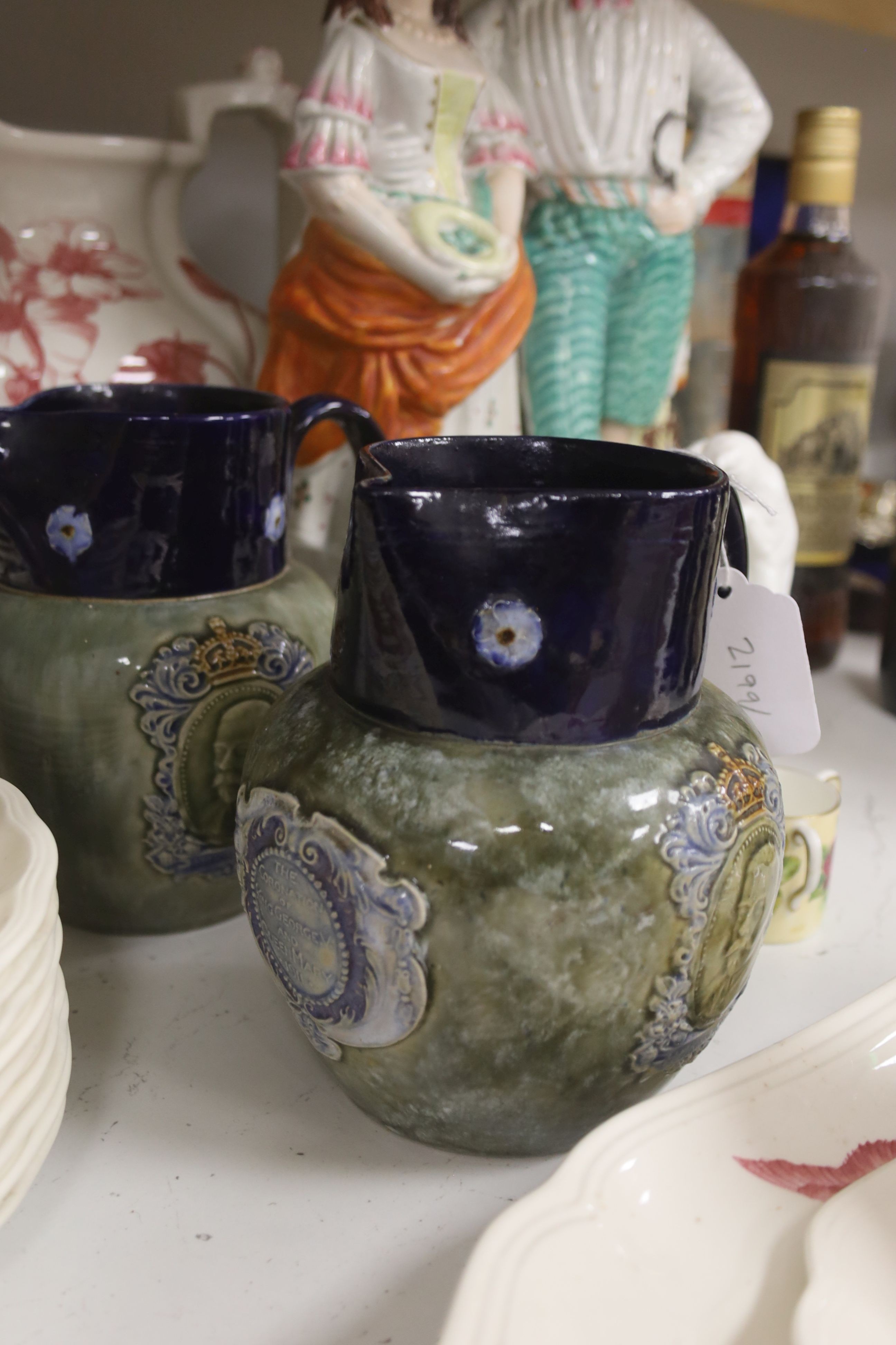 A pair of Doulton commemorative jugs, cat pail, miniature tyg and Staffordshire flatback, 40cm